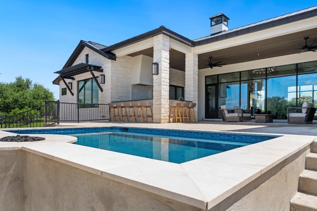 Custom Hill Country pool with fire pit and outdoor living